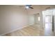 Bright bedroom with light hardwood floors and access to a hallway at 6388 W Donald Dr, Glendale, AZ 85310