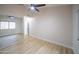 Spacious bedroom featuring a ceiling fan and light hardwood floors at 6388 W Donald Dr, Glendale, AZ 85310