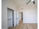 Spacious bedroom with wood-look floors, large closet, and a white door at 6388 W Donald Dr, Glendale, AZ 85310