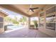 Inviting covered patio with ceiling fan provides a seamless transition to the stunning backyard pool at 6388 W Donald Dr, Glendale, AZ 85310
