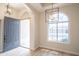 Bright foyer with natural light, an open doorway, and elegant light fixtures at 6388 W Donald Dr, Glendale, AZ 85310