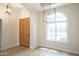 Bright foyer featuring a wood door, light fixture, and a half-moon window, complemented by wood-look floors at 6388 W Donald Dr, Glendale, AZ 85310