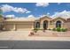 Inviting single-story home with a well-manicured front yard and three-car garage at 6388 W Donald Dr, Glendale, AZ 85310