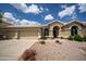 Lovely home with a three-car garage, neutral paint, and easy-care landscaping at 6388 W Donald Dr, Glendale, AZ 85310