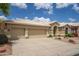 Well-maintained home featuring a three-car garage and a concrete driveway at 6388 W Donald Dr, Glendale, AZ 85310