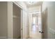 Bright hallway with white trim and access to a sliding closet at 6388 W Donald Dr, Glendale, AZ 85310