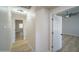 Bright hallway leading to bedrooms, featuring wood-look flooring and neutral-colored walls at 6388 W Donald Dr, Glendale, AZ 85310
