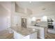Open kitchen with granite countertops, stainless steel appliances, white cabinets, and vaulted ceilings at 6388 W Donald Dr, Glendale, AZ 85310