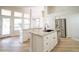 Island kitchen featuring granite countertops, white cabinets, stainless steel appliances, and an open concept design at 6388 W Donald Dr, Glendale, AZ 85310