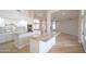 Bright, spacious kitchen featuring granite countertops, white cabinets, and an open floor plan at 6388 W Donald Dr, Glendale, AZ 85310