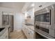 Beautiful kitchen featuring stainless steel appliances, granite countertops, and white cabinets at 6388 W Donald Dr, Glendale, AZ 85310