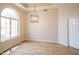 Bright living room featuring a half-moon window, wood-look flooring, and recessed lighting at 6388 W Donald Dr, Glendale, AZ 85310