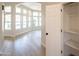 Sunlit living room with a view of the pool through expansive windows, featuring wood-look floors and a linen closet at 6388 W Donald Dr, Glendale, AZ 85310