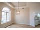 Bright living room featuring a half-moon window, wood-look flooring, recessed lighting, and kitchen access at 6388 W Donald Dr, Glendale, AZ 85310