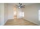 Bright main bedroom features a ceiling fan, wood-look floors, and natural light at 6388 W Donald Dr, Glendale, AZ 85310