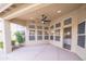 Covered patio with ceiling fan, neutral flooring and plenty of windows provides seamless indoor/outdoor living at 6388 W Donald Dr, Glendale, AZ 85310