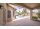 View of the private backyard oasis with a sparkling pool, lush greenery, and serene mountain views at 6388 W Donald Dr, Glendale, AZ 85310