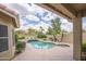 Backyard pool with a spa, desert landscaping, mature trees, and views of a distant mountain at 6388 W Donald Dr, Glendale, AZ 85310