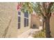 Exterior features gravel path, blooming tree, and a view of the home's architecture at 6388 W Donald Dr, Glendale, AZ 85310