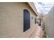 Exterior view of the side yard featuring gravel, a flagstone path, and home architecture at 6388 W Donald Dr, Glendale, AZ 85310