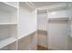Spacious walk-in closet featuring custom shelving for optimal organization and ample storage at 6388 W Donald Dr, Glendale, AZ 85310