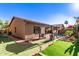 Exterior shot of the house highlights backyard's pool, putting green and patio at 712 W Jade Dr, Chandler, AZ 85248
