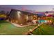 The backyard offers a putting green, patio seating and lovely pool at 712 W Jade Dr, Chandler, AZ 85248