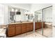 A bathroom featuring a bathtub, tile flooring, dual sinks, and a large mirror at 712 W Jade Dr, Chandler, AZ 85248