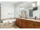 A bathroom featuring a tub, tile flooring, and dual sinks at 712 W Jade Dr, Chandler, AZ 85248