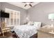 A bedroom featuring a decorative ceiling fan, shutters, and TV at 712 W Jade Dr, Chandler, AZ 85248