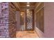 Inviting front entrance featuring a decorative door, stone accent wall, and tile flooring at 712 W Jade Dr, Chandler, AZ 85248