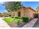 Beautiful home featuring lush landscaping, verdant lawn, a stone accent wall, and a sidewalk at 712 W Jade Dr, Chandler, AZ 85248