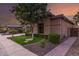 Beautiful home featuring lush landscaping, verdant lawn, a stone accent wall, and a sidewalk at 712 W Jade Dr, Chandler, AZ 85248