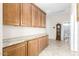 Hallway with wooden cabinets, granite countertops, decorative molding, and a grandfather clock at 712 W Jade Dr, Chandler, AZ 85248