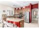 Well-lit kitchen boasting a large island with seating, granite countertops, and stainless steel appliances at 712 W Jade Dr, Chandler, AZ 85248