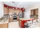 Spacious kitchen features granite countertops, stainless steel appliances, and a large island with bar seating at 712 W Jade Dr, Chandler, AZ 85248