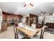 Open floor plan with kitchen island bar seating flowing into living and dining area with tiled floors at 712 W Jade Dr, Chandler, AZ 85248