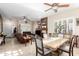 Open-concept living and dining room featuring tiled floors, ceiling fans and a fireplace at 712 W Jade Dr, Chandler, AZ 85248