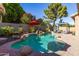 Backyard pool with a waterfall, brick patio and landscaping at 712 W Jade Dr, Chandler, AZ 85248