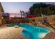 Backyard pool with a waterfall feature, surrounding patio, and sports equipment at 712 W Jade Dr, Chandler, AZ 85248