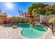 The backyard pool features a waterfall, basketball hoop, and desert landscaping at 712 W Jade Dr, Chandler, AZ 85248