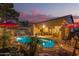 Backyard pool area featuring lush landscaping, stone accents, and ample seating for outdoor entertaining at 712 W Jade Dr, Chandler, AZ 85248