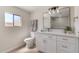Bright bathroom with modern vanity, updated fixtures, a decorative mirror and tiled shower at 7442 E Baseline Rd, Mesa, AZ 85209