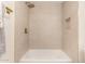 Modern shower with tiled walls, golden rainfall showerhead and fixtures, plus a recessed storage niche at 7442 E Baseline Rd, Mesa, AZ 85209