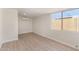 Bright and spacious room featuring sleek vinyl floors, modern air conditioning, and a large sunlit window at 7442 E Baseline Rd, Mesa, AZ 85209