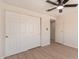 Bright and airy bedroom featuring wood-look floors and a large closet with sliding doors at 7442 E Baseline Rd, Mesa, AZ 85209