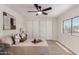 Light and airy bedroom with closet, ceiling fan, neutral decor, and wood-look floors at 7442 E Baseline Rd, Mesa, AZ 85209