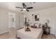 Light and airy bedroom with ensuite bathroom, ceiling fan, neutral decor, and wood-look floors at 7442 E Baseline Rd, Mesa, AZ 85209