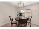 Cozy dining area with a round table, seating for four, a decorative floral centerpiece, and a window view at 7442 E Baseline Rd, Mesa, AZ 85209