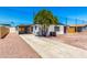 Exterior features a large driveway, desert landscaping, mature tree and covered parking at 7442 E Baseline Rd, Mesa, AZ 85209